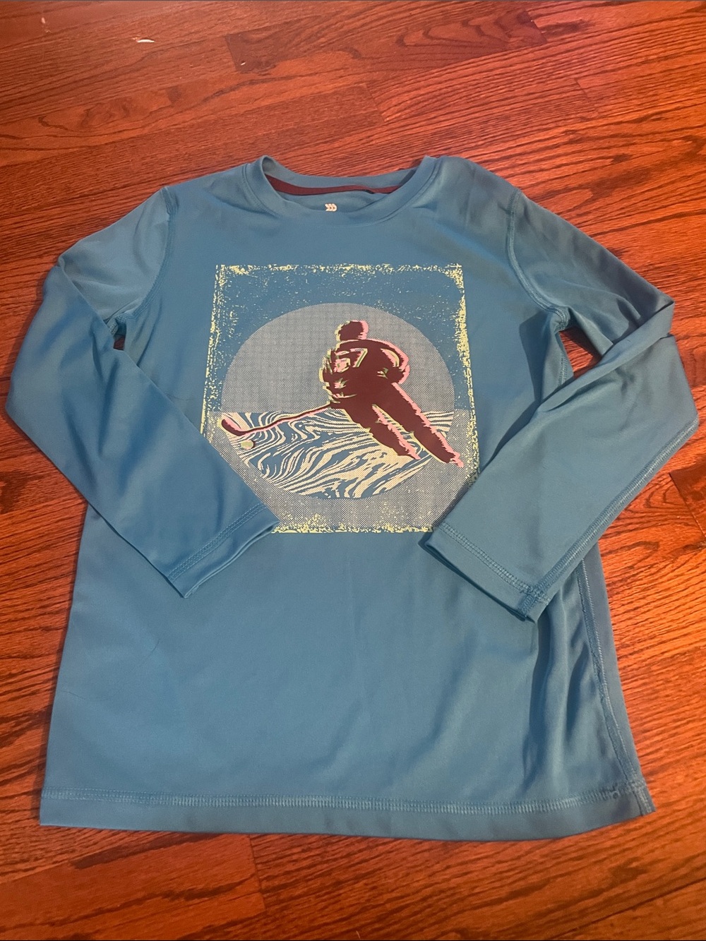 all in motion Teal Blue Long-Sleeve top with Hockey Player Graphic